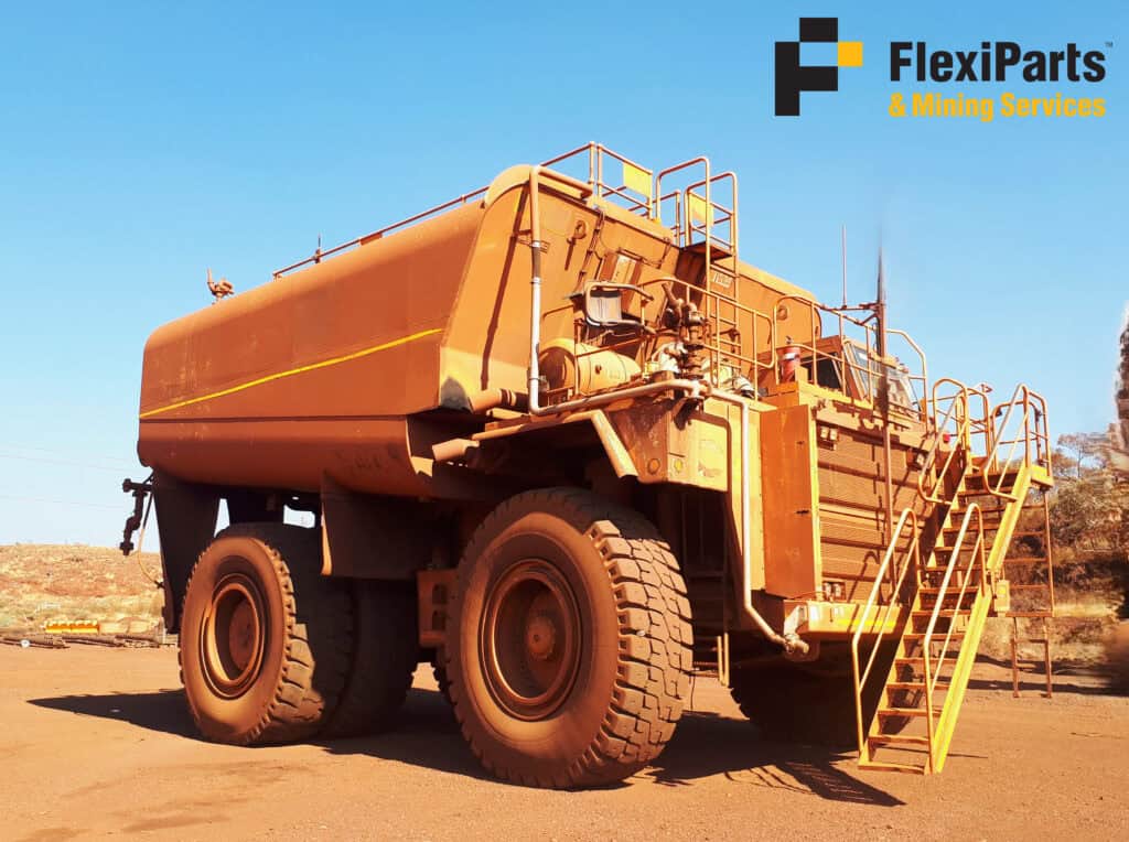 Heavy-duty Cat 785D water cart used in mining and construction sites.