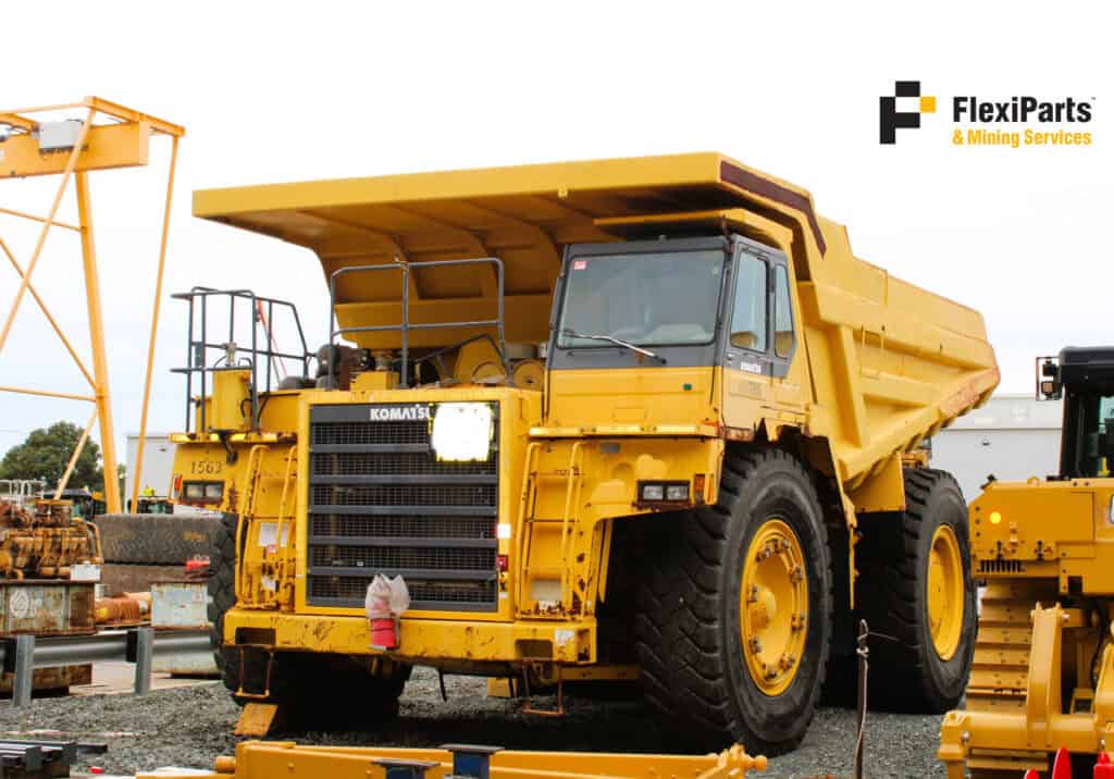 Heavy-duty Komatsu HD785-5 dump truck in yellow for mining and construction.