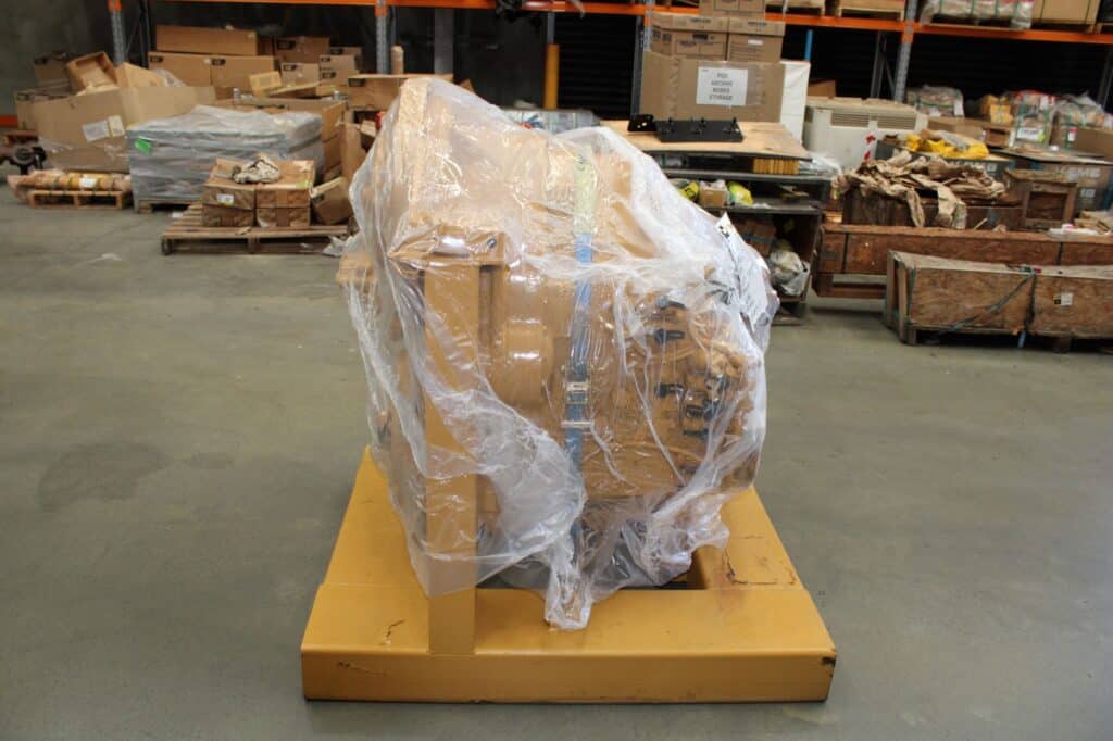 Rebuilt transmission in protective plastic wrap at FlexiParts warehouse.